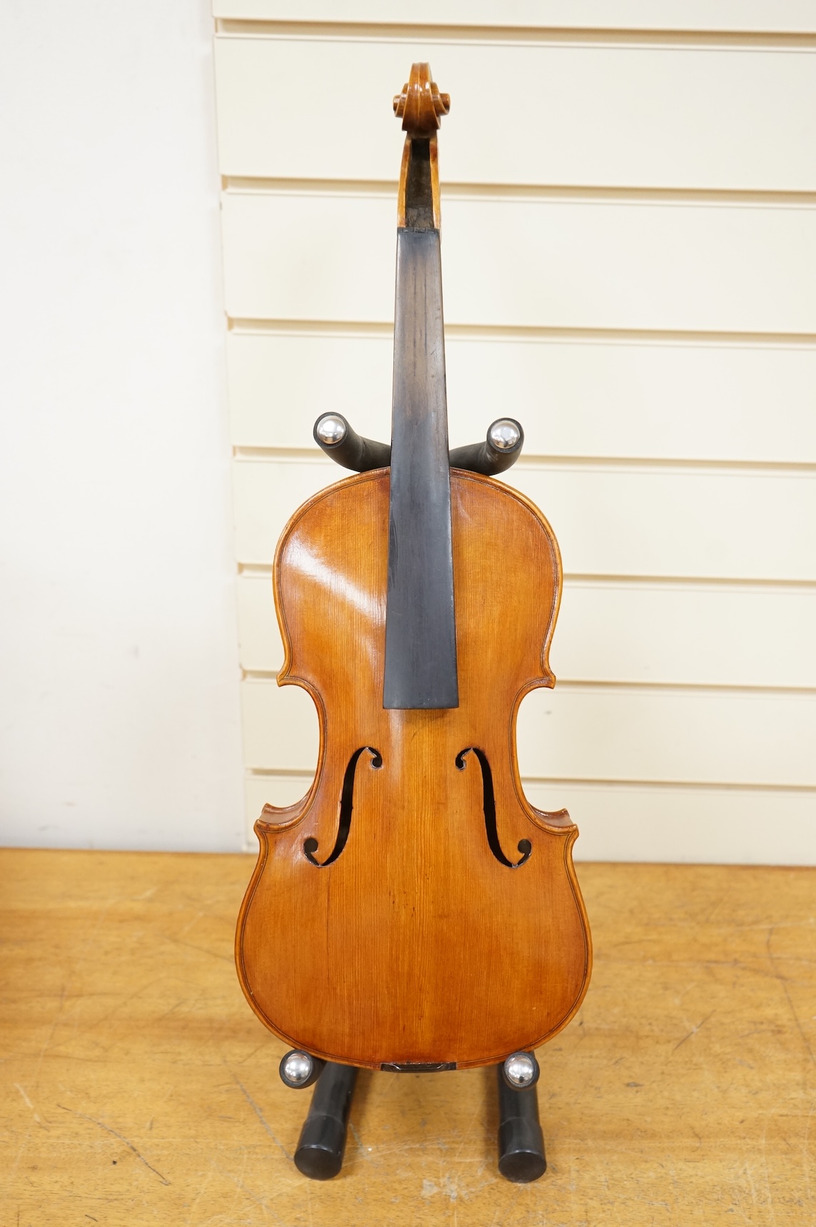 Four violins; a German Dresden violin, together with further two German violins, and a Saxony violin, three in cases or the remains of cases.